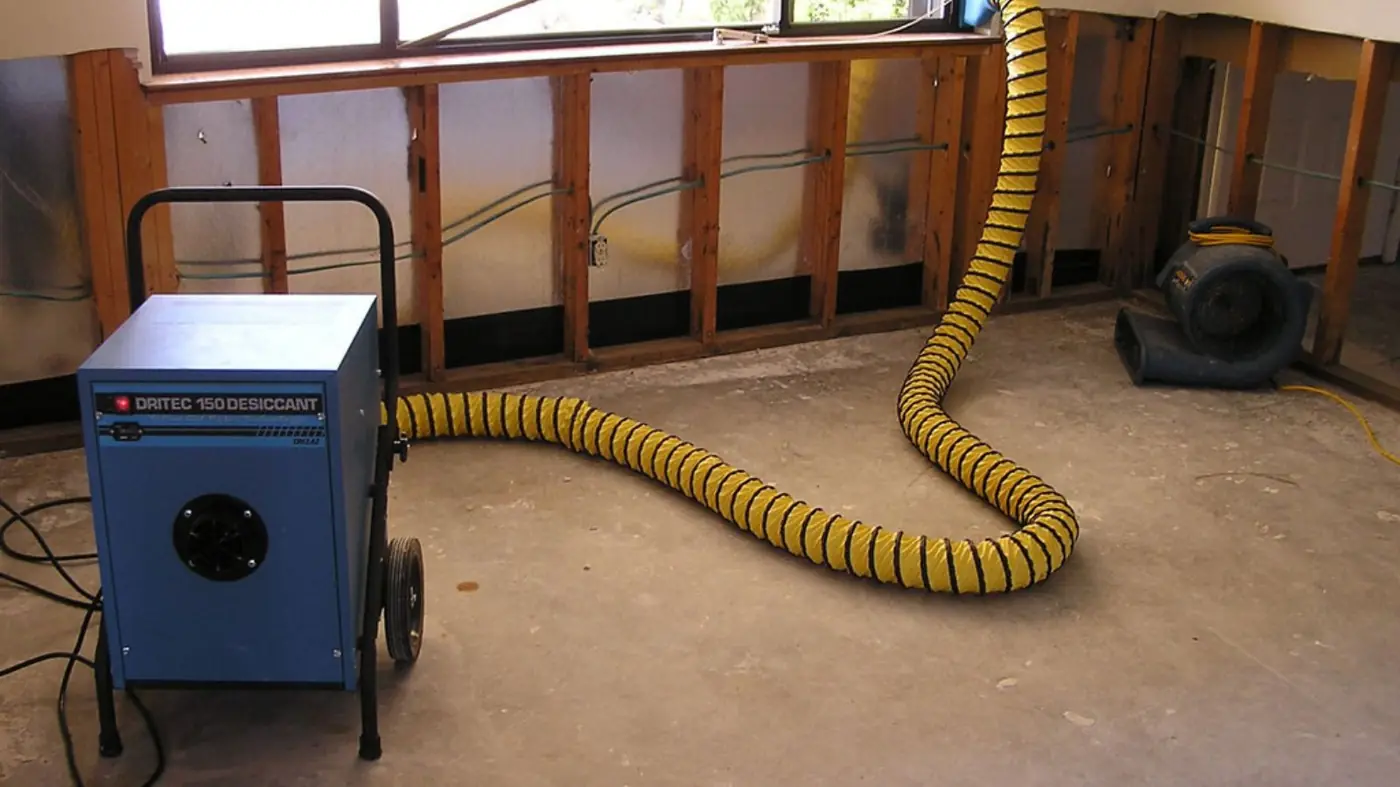 Restoration equipment drying a water damaged room after the walls were opened